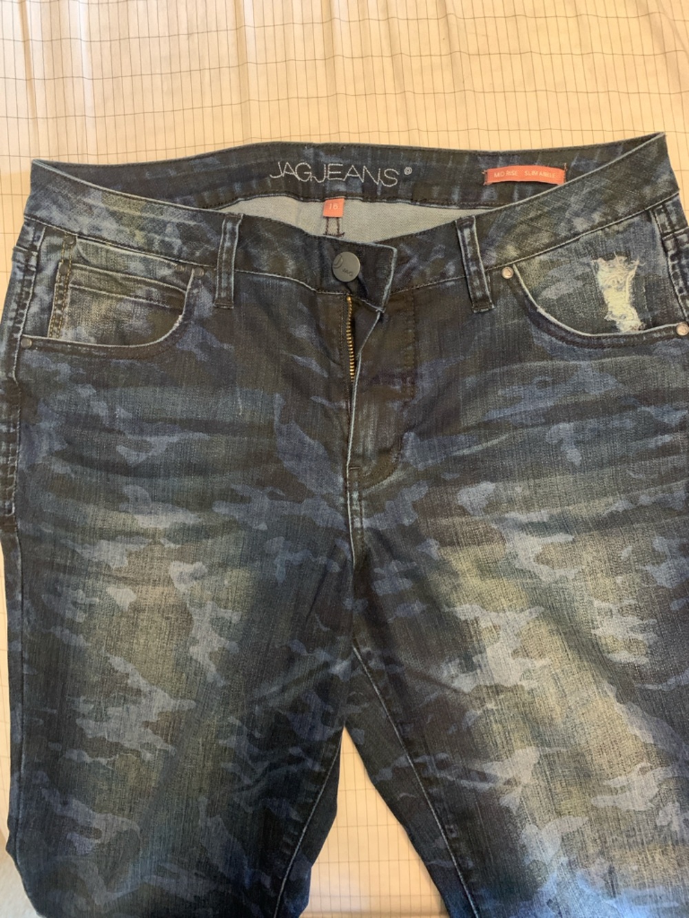 Distressed camo jeans